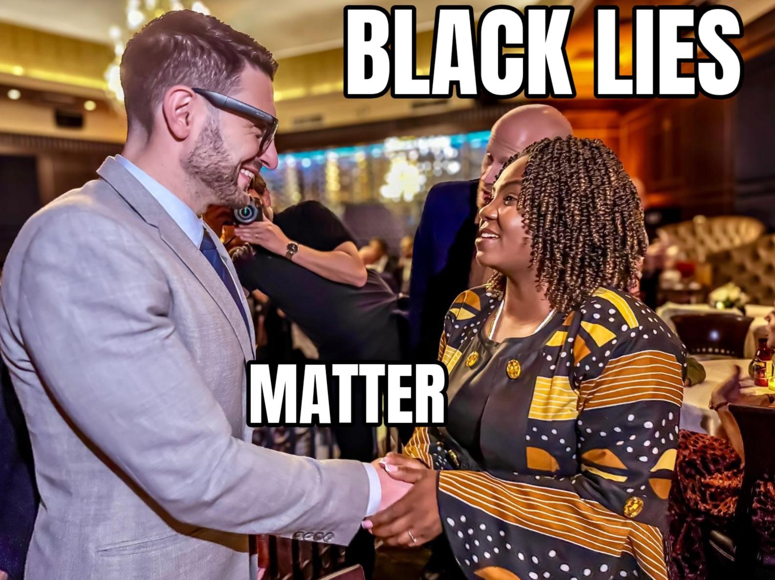 A meme of alexander soros shaking hands with a liteskint black person with the text on the meme saying black lies matter