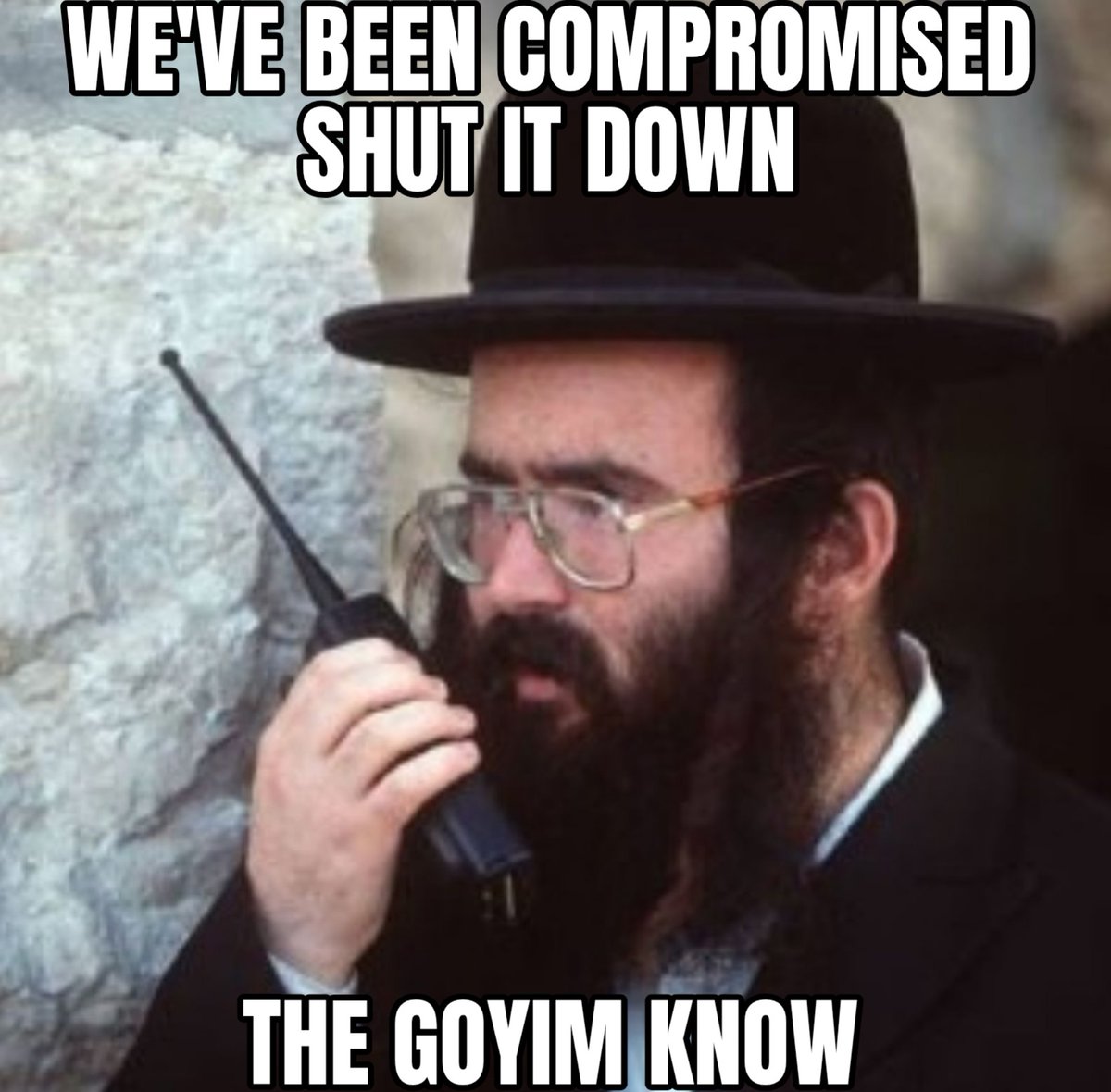 a meme of a jew on a walkie talkie saying we've been compromised, shut it down, the goyim know.